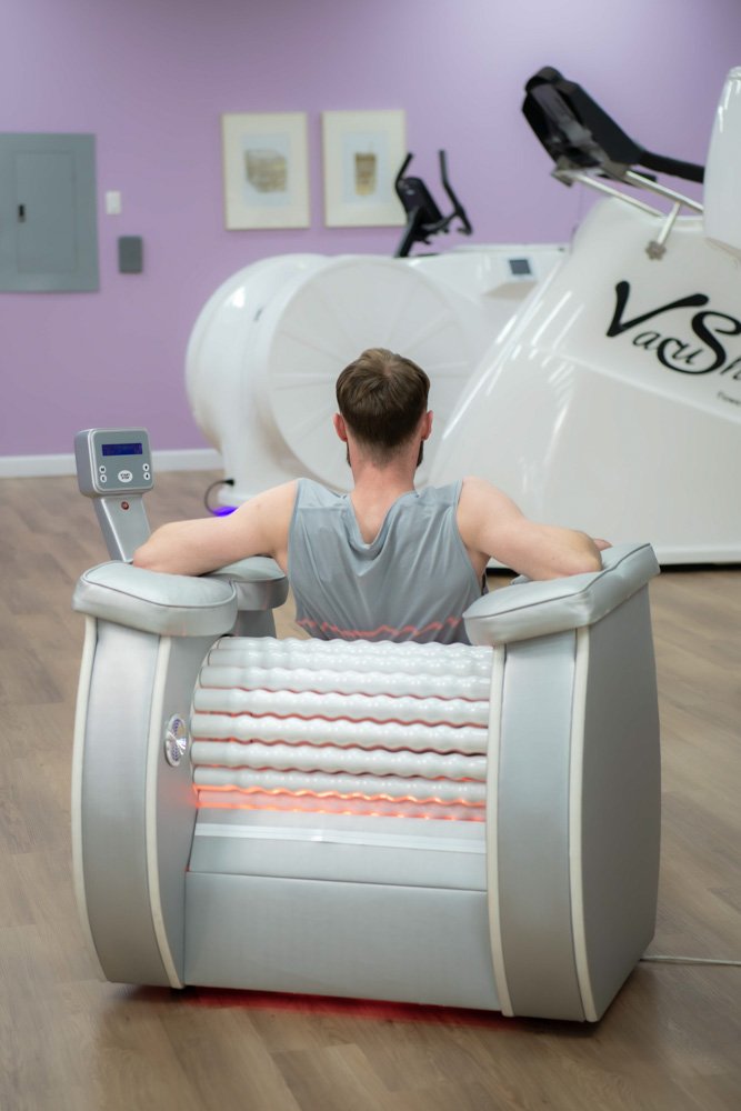 Client using Roll Shaper wooden rollers during a guided body contouring session